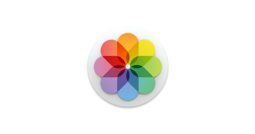 A circular logo with eight overlapping petals, each a different color, creating a flower-like design reminiscent of the vibrant hues in an iOS 14 photo library. The colors include red, orange, yellow, green, blue, and purple, arranged in a symmetrical pattern on a white background.