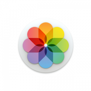 A circular logo with eight overlapping petals, each a different color, creating a flower-like design reminiscent of the vibrant hues in an iOS 14 photo library. The colors include red, orange, yellow, green, blue, and purple, arranged in a symmetrical pattern on a white background.