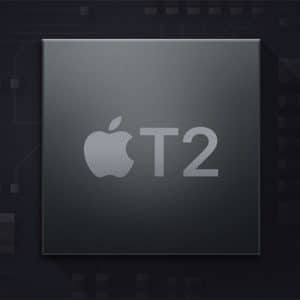 Dark-themed close-up image of an Apple T2 security chip with the Apple logo and "T2" prominently featured on its surface. The background resembles a circuit board, adding a tech-centric context to the image.