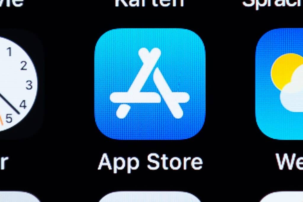 Close-up of the App Store icon on a smartphone screen. The icon features a stylized white "A" on a blue background with "App Store" written below. Adjacent icons for other apps are partially visible, reflecting the surge in app purchases during the COVID-19 pandemic.