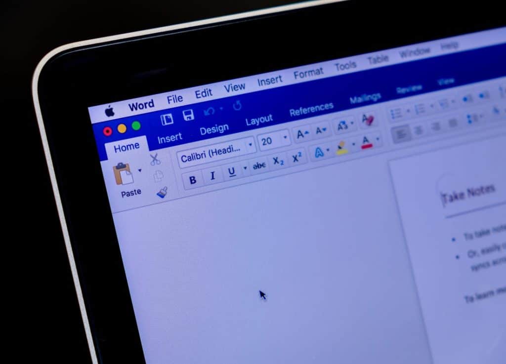 A close-up of a computer screen displaying a Word document in Microsoft Office for Mac. The menu bar at the top shows options like File, Edit, View, Insert, and the toolbar beneath contains various formatting tools. The document appears to be in editing mode with visible text formatting options.