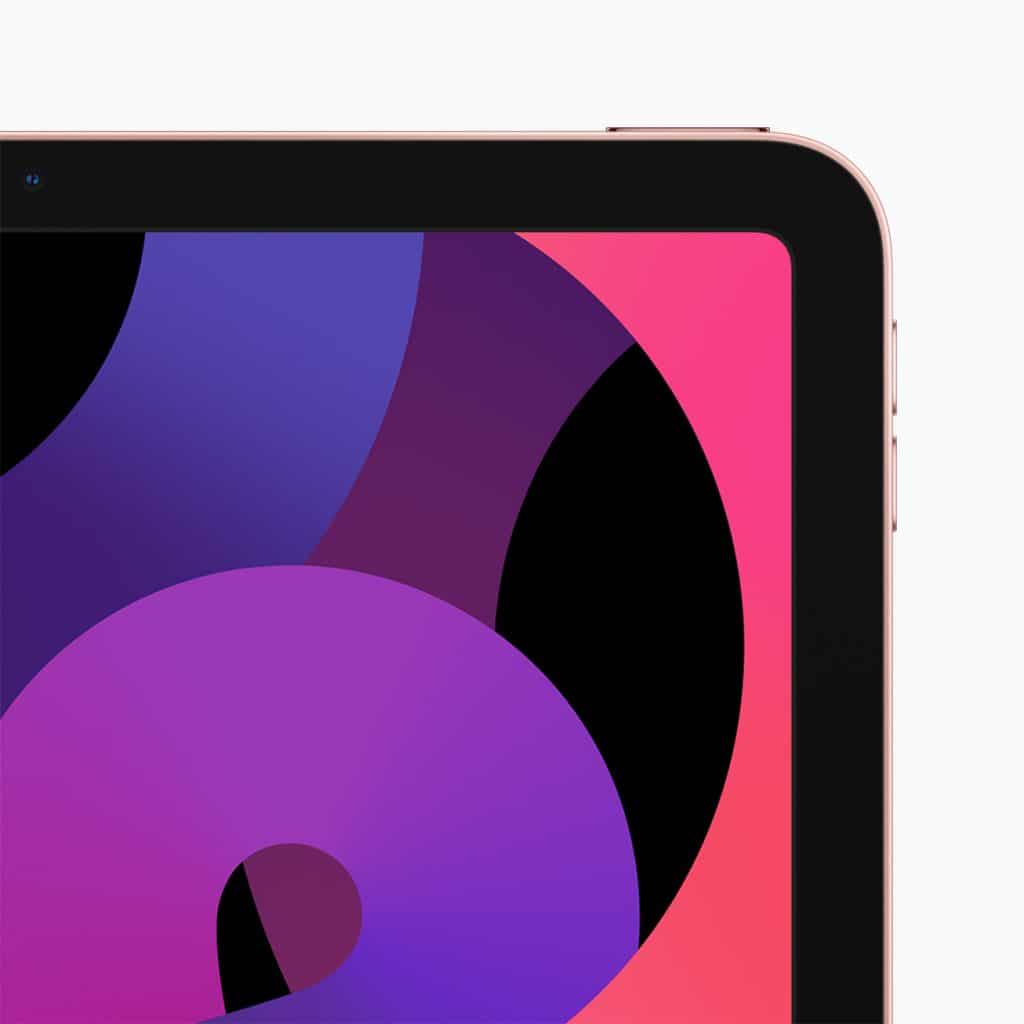 Close-up of an iPad screen displaying an abstract wallpaper with overlapping circular shapes in shades of purple, blue, and pink. The iPad has a gold-colored bezel, with a small part of the front camera visible on the top edge.