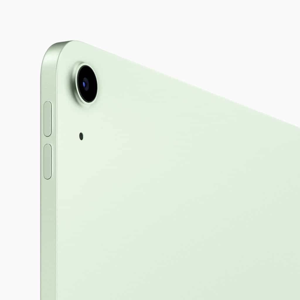 A close-up view of the top left corner of a light green tablet. The camera lens, a small microphone hole, and volume buttons are visible along the edge of the device. The tablet's sleek and minimalist design is emphasized.