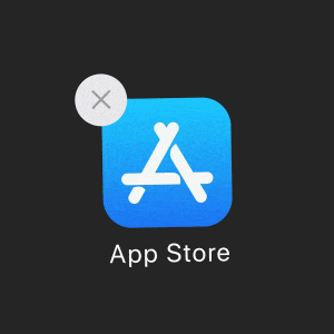 An App Store icon on a dark background with a white 'X' in a light gray circle overlapping the top left corner of the icon. The blue square features the white App Store logo and "App Store" below it, marking one of the 5 reasons to get excited for macOS Big Sur, which launches tomorrow.