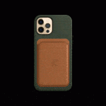 A smartphone with a green MagSafe case and a brown leather wallet attachment is displayed against a black background. The phone boasts three camera lenses in the top-left corner. The leather wallet features an embossed Apple logo in the center.