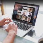 Illustration of a MacBook showcasing how to share your screen on macOS during a video call, featuring the FaceTime interface with options to share your screen or a specific app window.