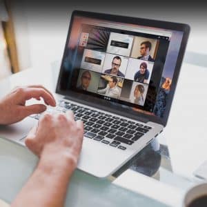 Illustration of a MacBook showcasing how to share your screen on macOS during a video call, featuring the FaceTime interface with options to share your screen or a specific app window.