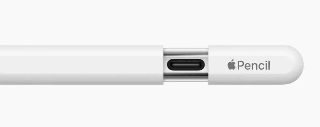 Close-up of a Lightning to headphone jack adapter connected to an iPhone showcasing wired audio compatibility.