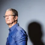 Apple iPhone and MacBook inventory stockpiled in a warehouse, highlighting the tariff-driven import surge and looming price hikes for 2025.