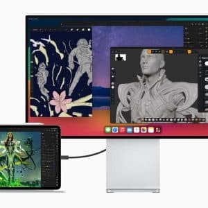 A computer monitor displaying a digital design workspace with a stylized astronaut, a flower, and a 3D model. The monitor is connected to a tablet showing a vibrant artwork of a futuristic character in green attire. Both devices are showcasing creative content.