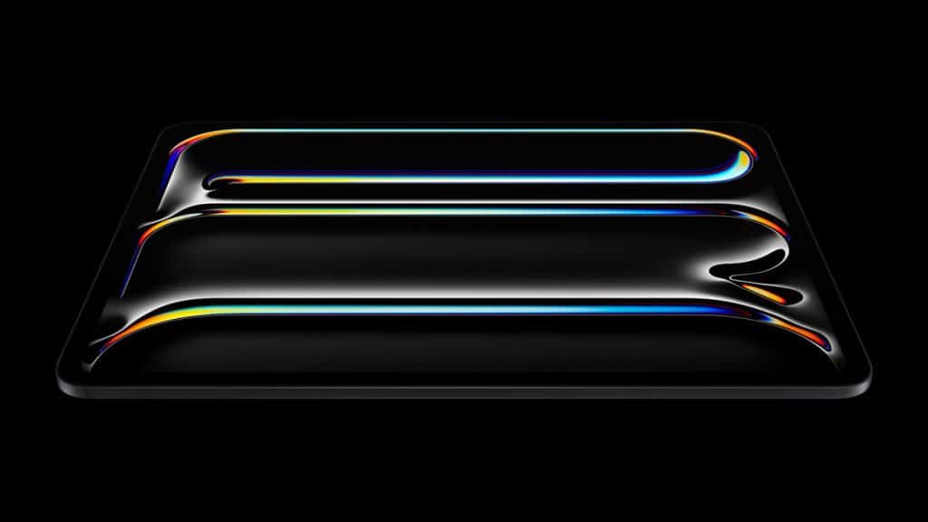 A sleek iPad Pro with a glossy, black surface and an OLED screen displays three curved, colorful neon lines glowing against the dark background. The lines radiate hues of blue, yellow, red, and green, creating a vibrant, futuristic design powered by the advanced M4 Chip.