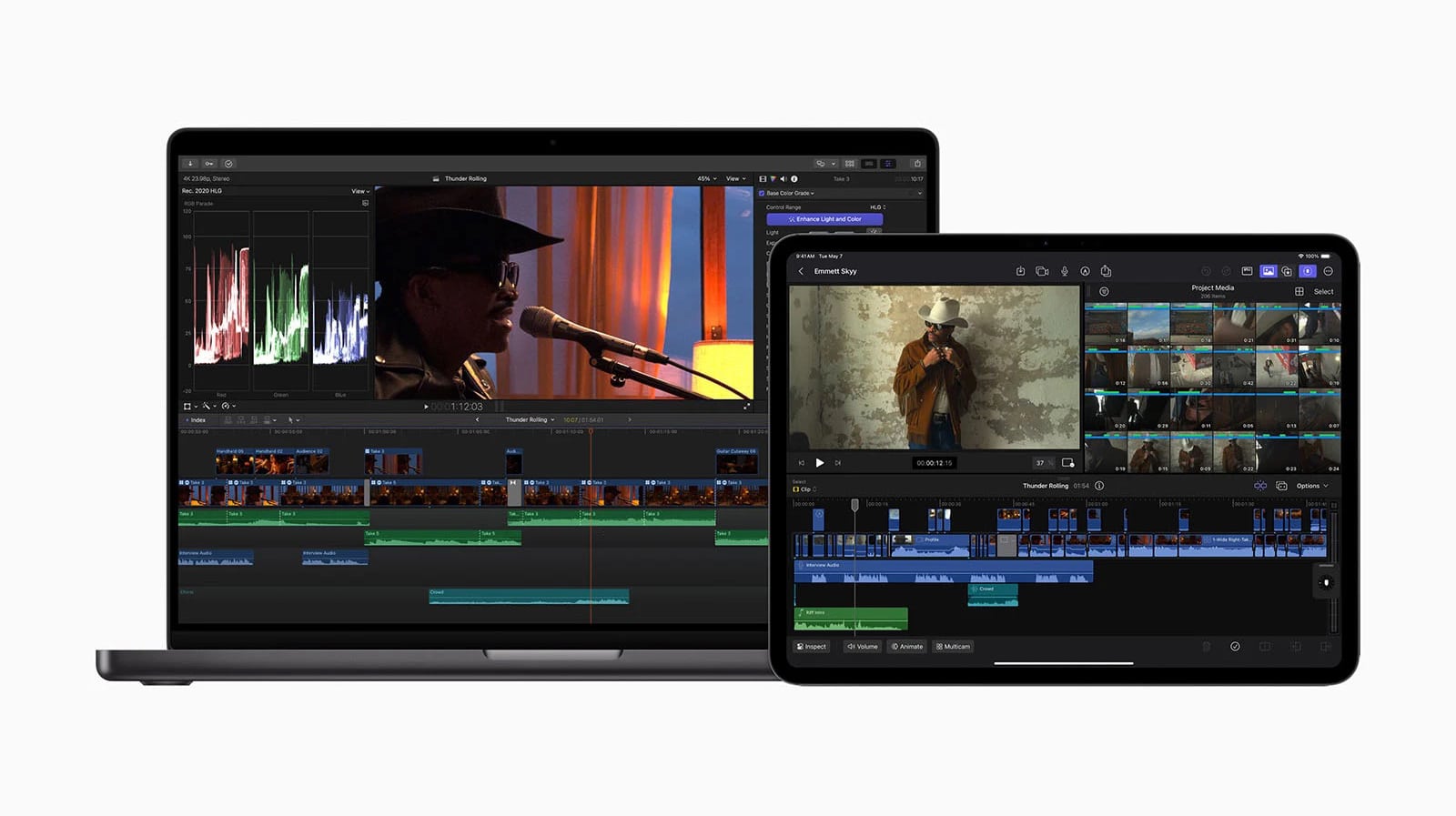 A laptop and a tablet display video editing software. The laptop screen shows various editing timelines, color grading graphs, and a person speaking into a microphone. An iPhone on the side displays the App Store. The tablet screen shows multiple video clips being edited and another person wearing a hat.