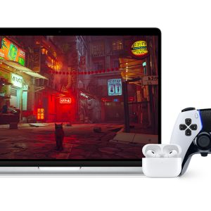 A laptop displaying a video game scene featuring a cat standing in an illuminated, neon-lit urban alleyway. In front of the laptop are a pair of wireless earbuds in a charging case, an iPhone with notifications from the latest Apple event, and a game controller.