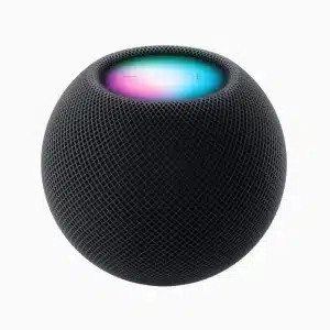 A black, spherical smart speaker with a mesh surface, the Apple HomePod mini in Midnight Color features a top that glows with blue, pink, and purple hues and has subtle plus and minus symbols. The background is plain white.