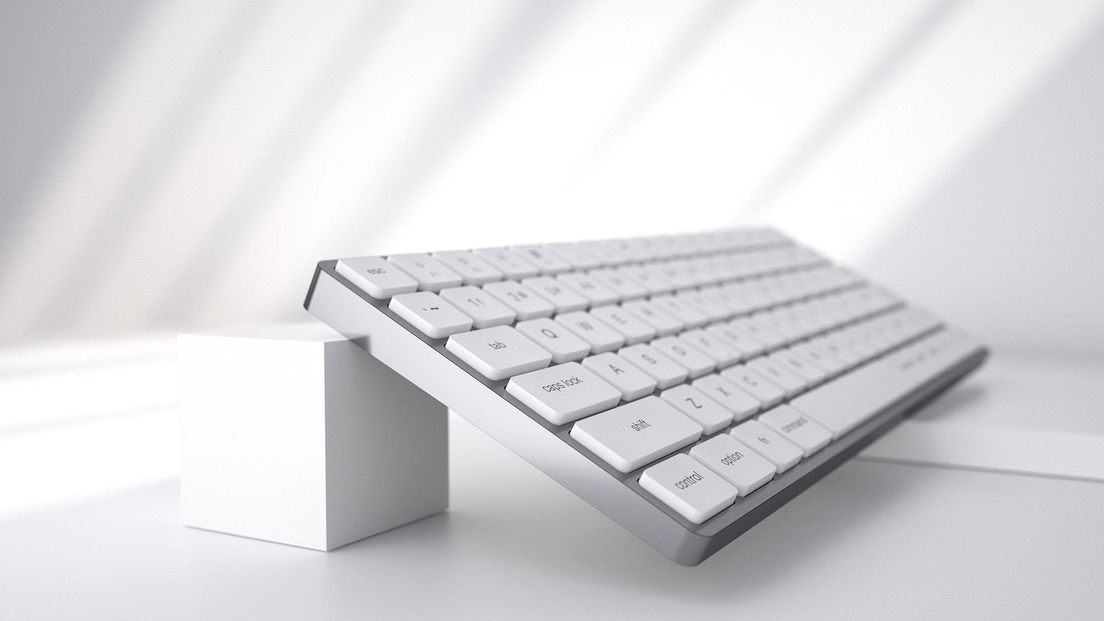 A sleek, white computer keyboard is angled upwards, with the front end elevated by a small white cube on a clean, white surface. Sunlight casts soft shadows across the scene, creating a minimalist and modern aesthetic that perfectly complements Mac users' preference for seamless keyboard integration.