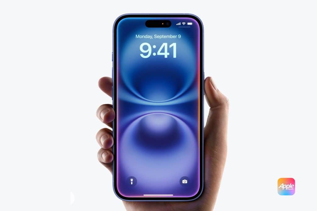 Face ID Not Working: A hand holds a blue smartphone showing the lock screen with the time set to 9:41 and the date to Monday, September 9. The phone has a pill-shaped camera cutout at the top. The AppleMagazine logo is visible in the bottom right corner of the image.