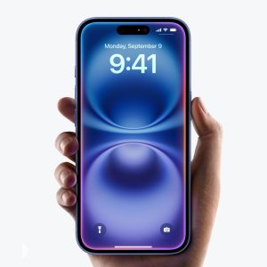 Face ID Not Working: A hand holds a blue smartphone showing the lock screen with the time set to 9:41 and the date to Monday, September 9. The phone has a pill-shaped camera cutout at the top. The AppleMagazine logo is visible in the bottom right corner of the image.