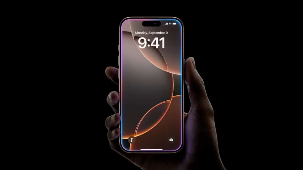 A hand holds a modern iPhone 16 Pro with a sleek, thin design against a black background. The screen displays the time as 9:41 and the date as Monday, September 9. The wallpaper features a minimalistic design with curved lines and gradients in warm tones, highlighting its major features.