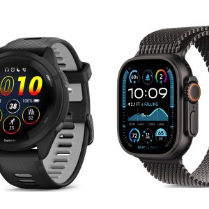 Garmin vs Apple Watch: Two smartwatches displayed side by side highlight the Garmin vs Apple Watch comparison. The left one is a Garmin watch with a round face showing various health and fitness metrics. The right one is an Apple Watch with a square face displaying detailed health stats and weather information. Both have black bands.