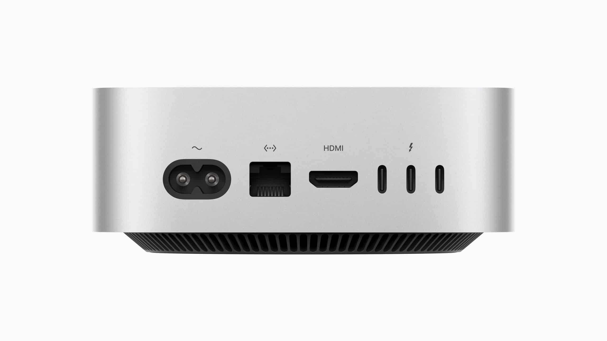 The new Mac mini boasts a sleek silver design with a compact and minimalistic back panel, featuring several ports: power input, Ethernet, HDMI, and multiple USB-C or Thunderbolt options.