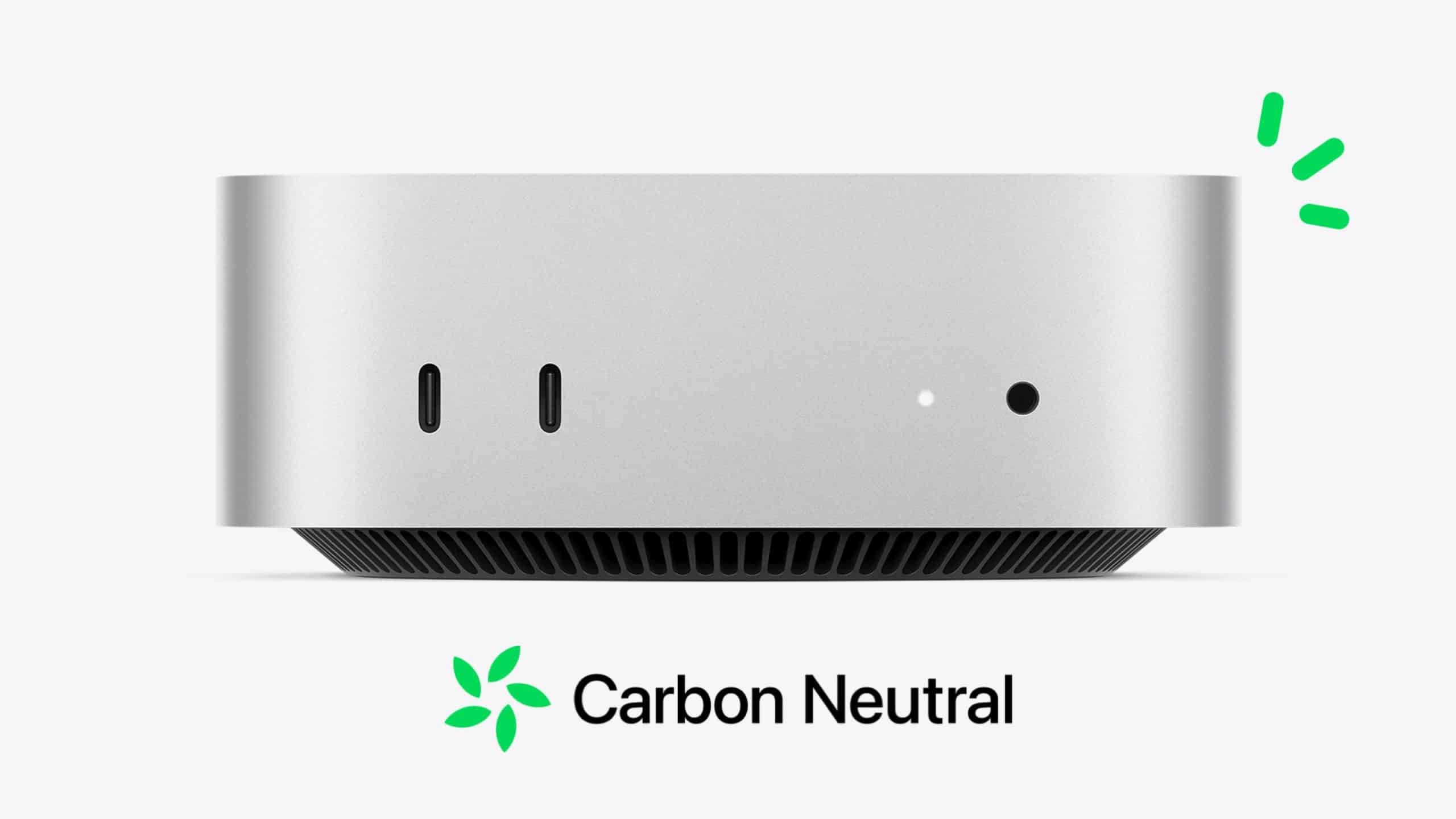 Front view of a compact, silver-colored electronic device, reminiscent of the sleek Mac mini, with two USB-C ports and one headphone jack. Below it is the text "Carbon Neutral" with a green leaf symbol. Green accents are visible on the top right, adding an eco-friendly Apple touch.