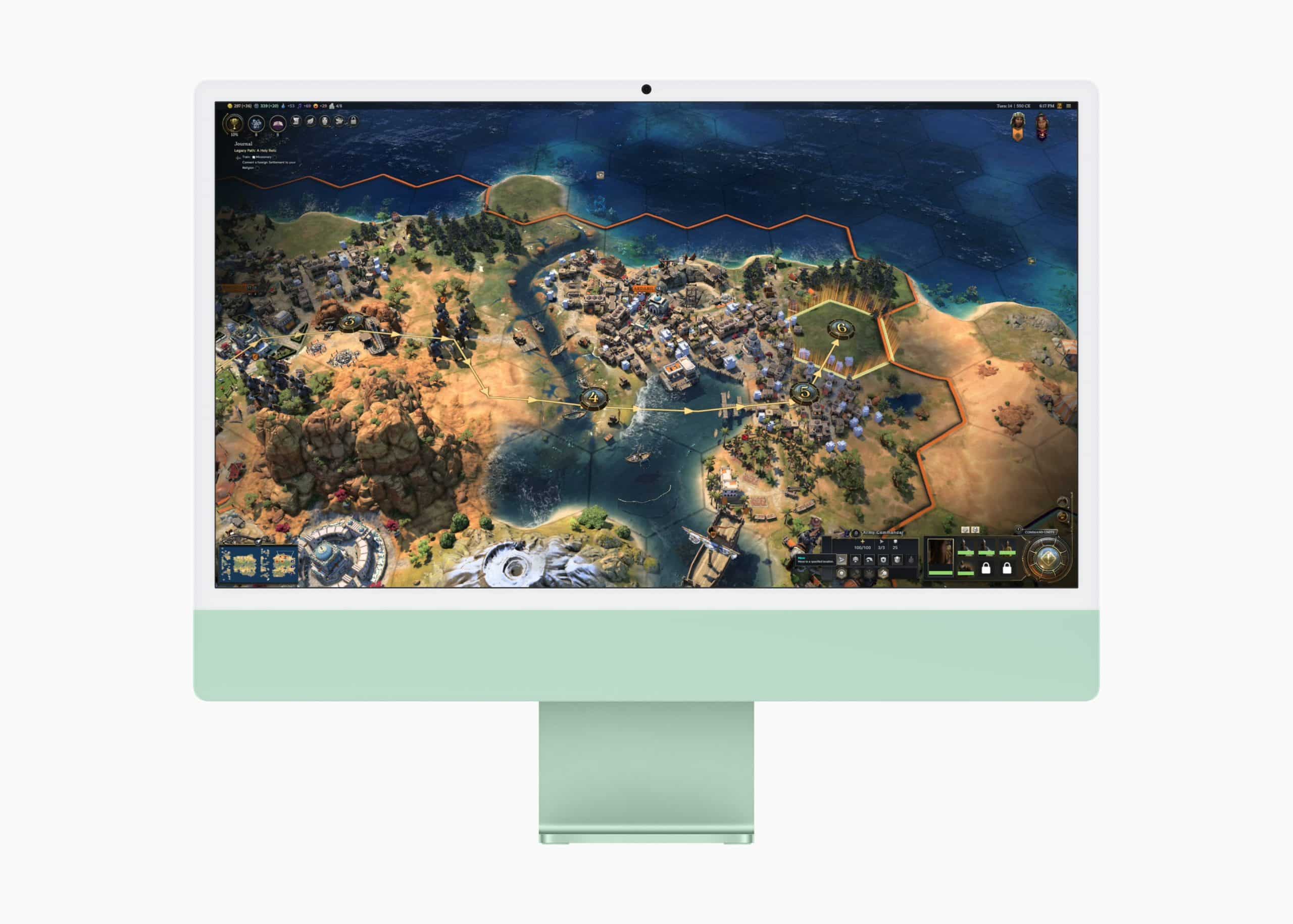 A desktop computer with a green stand displays a strategy game screen. The game shows a detailed map with land, sea, and resources, featuring various terrains, hexagonal grid, and icons, suggesting a civilization-building game.