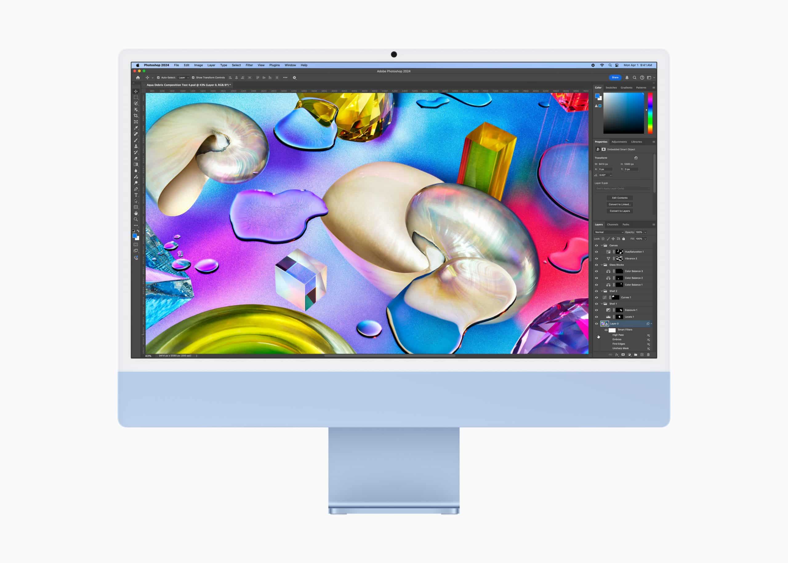 A blue desktop computer displaying digital artwork with colorful abstract shapes and textures, including shells and gemstones, on the screen. The interface suggests image editing software with visible tools and layers on the right side.