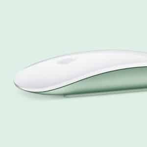 A sleek, flat white computer mouse with an Apple logo, shown in profile on a soft mint green background. The bottom part of the mouse is light green, creating a modern and minimalist look.