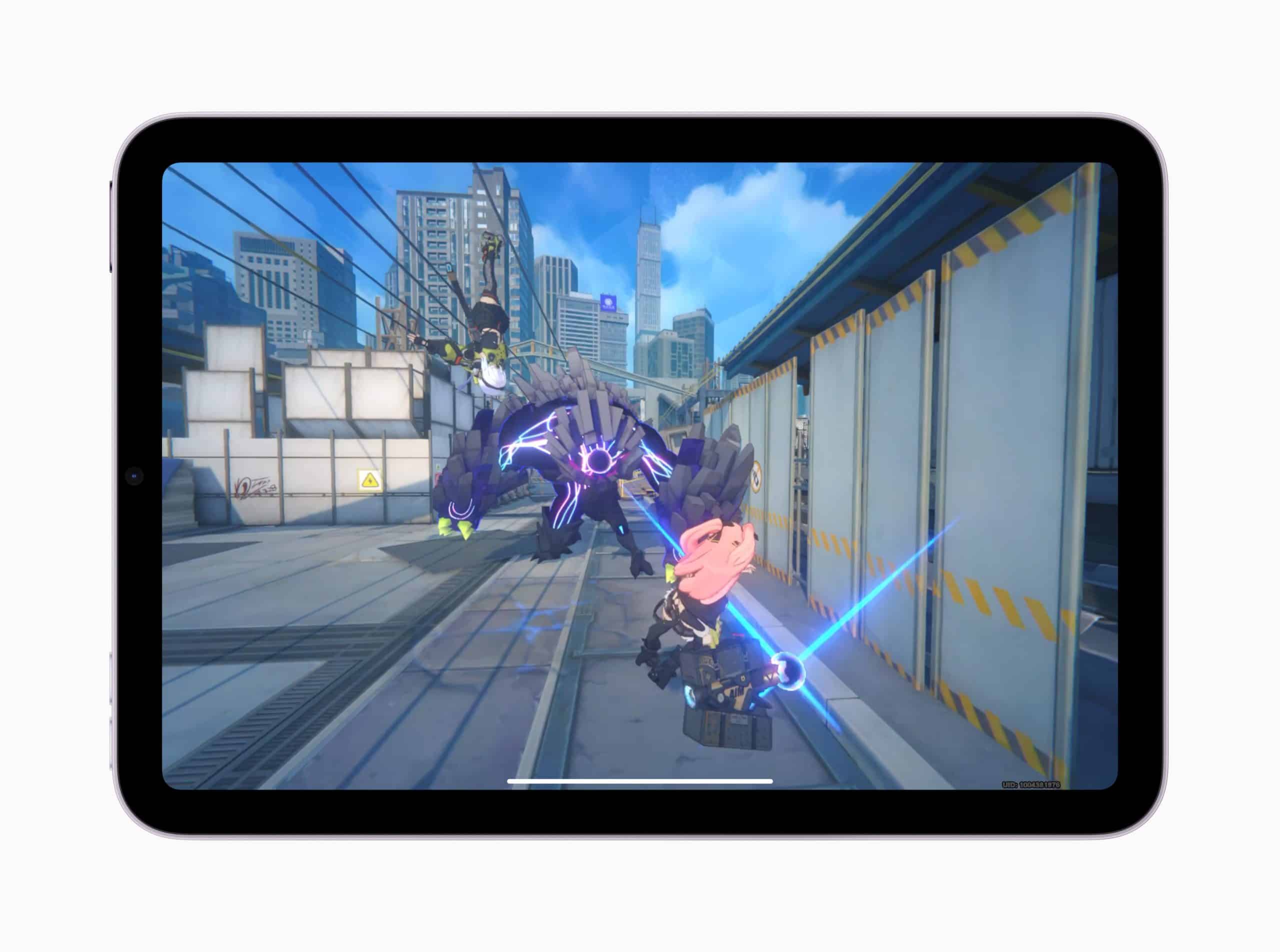 On the sleek screen of an iPad Mini, a video game unfolds where a character with pink hair wields a sword, facing off against a massive robotic creature. The power of the A17 Pro Chip brings every detail to life against the backdrop of towering city buildings and a cloudy blue sky.