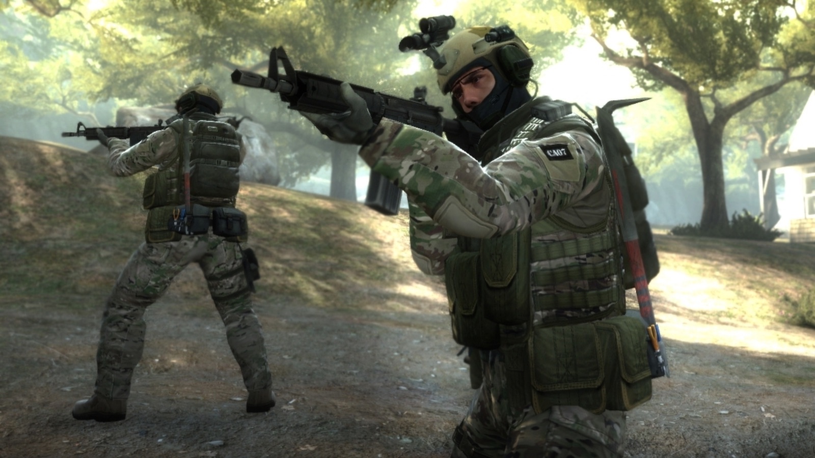 Two soldiers in camouflage gear are aiming rifles, reminiscent of a high-stakes Counter-Strike mission, in a forested area during daylight. One crouches, peering through a scope, while the other stands ready. Sunlight filters through the trees, casting dappled shadows akin to rare M4A1 skins in a collector's guide.