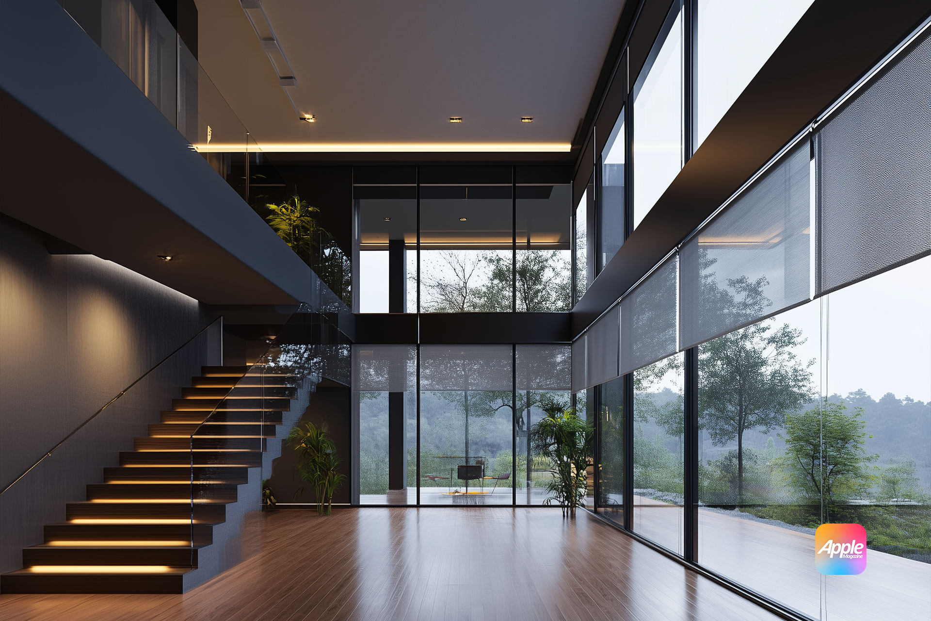 A modern interior with motorized shades covering large glass windows, a staircase with illuminated steps, and hardwood floors. The room is spacious with plants, offering a scenic view of trees outside. A small logo graces the lower right corner, adding a touch of modern home essentials.