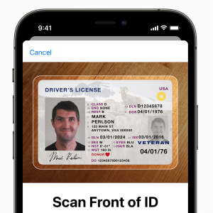 A smartphone screen showcasing a digital driver's license, featuring a photo, name, address, barcode, and personal details. In the backdrop, an Apple logo subtly highlights that it's an Apple device equipped with cutting-edge Digital IDs technology.