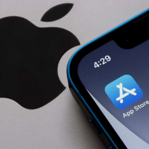 A close-up of an iPhone screen reveals recent App Store changes, with the familiar icon set against a blue background and a stylized white "A." The phone's time reads 4:29, while the iconic Apple logo subtly enhances the backdrop.