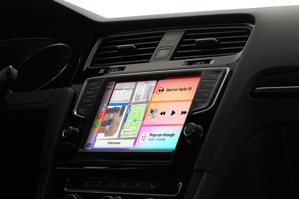 A car dashboard displaying the iOS 18.4 CarPlay change interface with improved navigation and media controls.