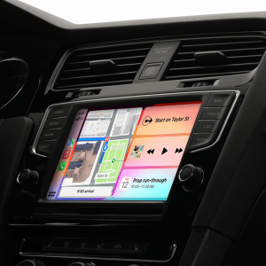 A car dashboard displaying the iOS 18.4 CarPlay change interface with improved navigation and media controls.