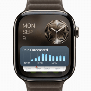 An Apple Watch running watchOS 11.3 Beta 3 displays the date Monday, September 9, with a detailed weather forecast. The screen shows rain predicted over the next hour in intervals and a modern clock face. An Apple logo graces the bottom right corner.