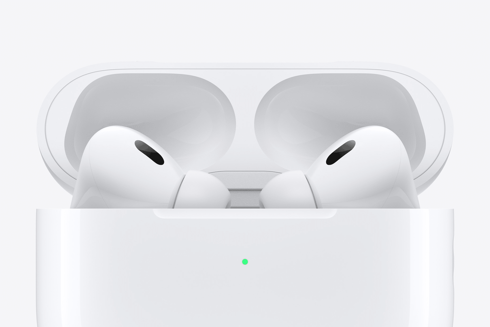 Close-up of two white wireless earbuds resembling Fake AirPods Pro in an open charging case, set against a plain white background. A small green light on the case signals charge status.