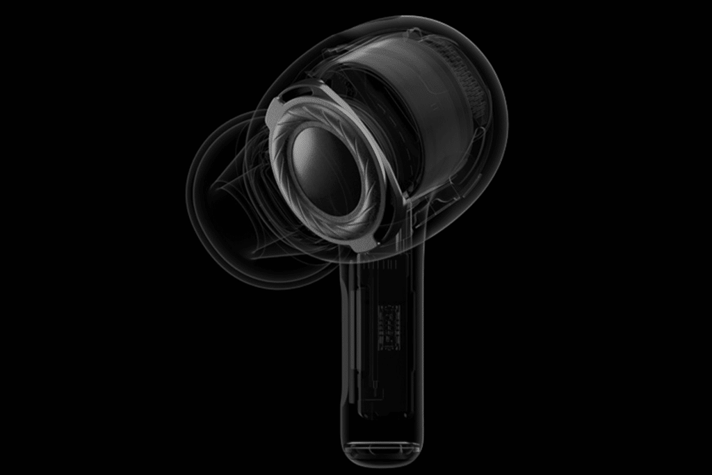 A transparent digital model of the AirPods Pro 2 is displayed, showcasing the internal components and design. Set against a solid black background, it highlights its intricate mechanical details and new hearing aid feature.