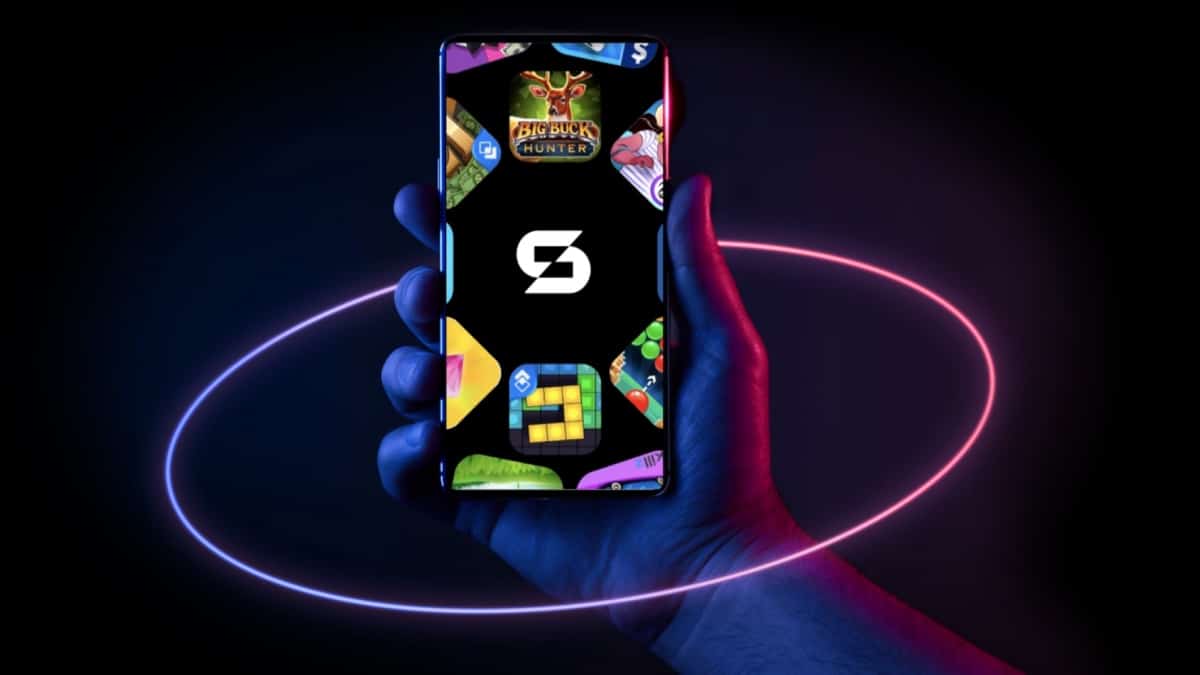 A hand holds a smartphone displaying colorful app icons around a central logo resembling a stylized "S." The scene is illuminated with neon purple and pink rings against a dark background, creating a vibrant and futuristic atmosphere reminiscent of 2025.