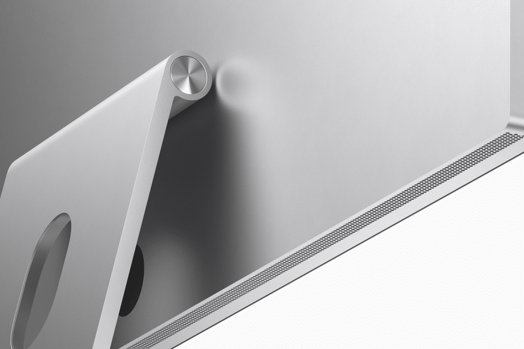 Close-up of the back of an Apple Studio Display, showcasing its silver finish with Mini-LED technology. The sleek, adjustable stand and part of the ventilation grille are visible at the bottom, while the metallic finish reflects light, emphasizing its modern design.