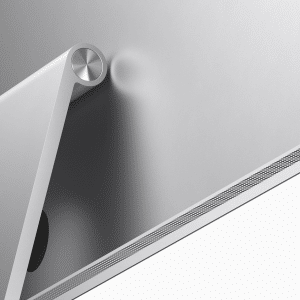 Close-up of the back of an Apple Studio Display, showcasing its silver finish with Mini-LED technology. The sleek, adjustable stand and part of the ventilation grille are visible at the bottom, while the metallic finish reflects light, emphasizing its modern design.