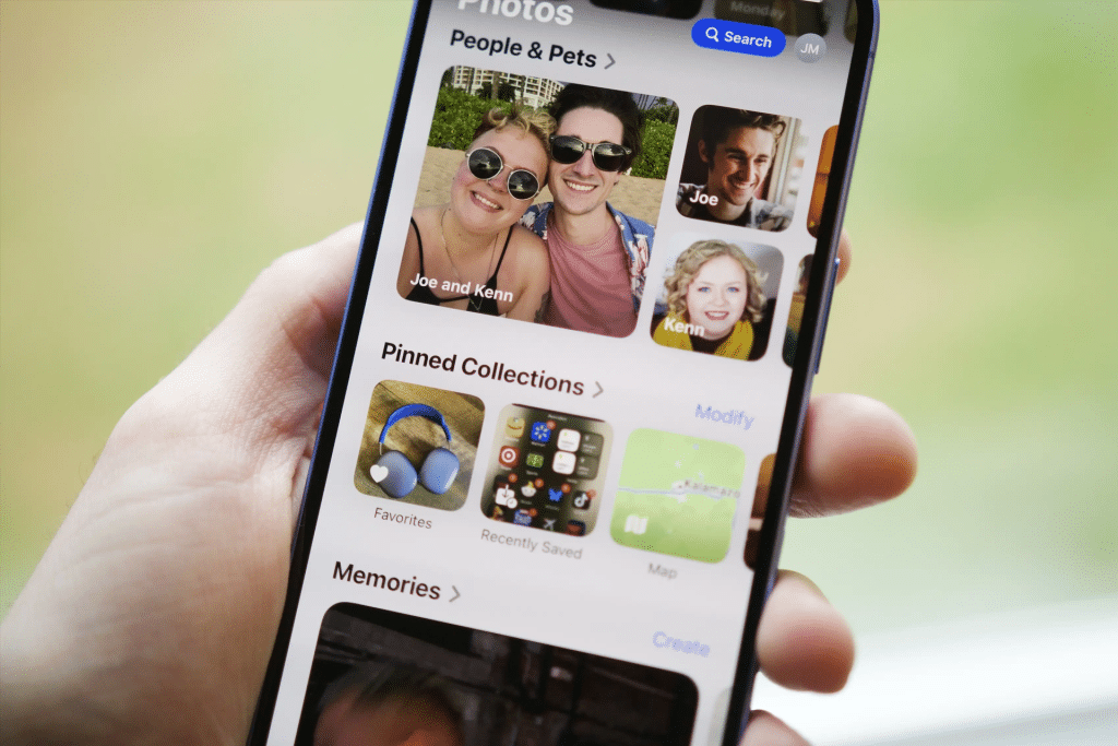 iPhone screen displaying the Photos app with AirDrop enabled, transferring photos wirelessly to a Mac, showcasing iCloud Photos and AirDrop for seamless media sharing.