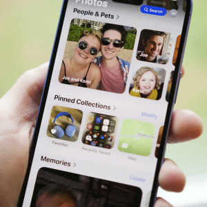 iPhone screen displaying the Photos app with AirDrop enabled, transferring photos wirelessly to a Mac, showcasing iCloud Photos and AirDrop for seamless media sharing.