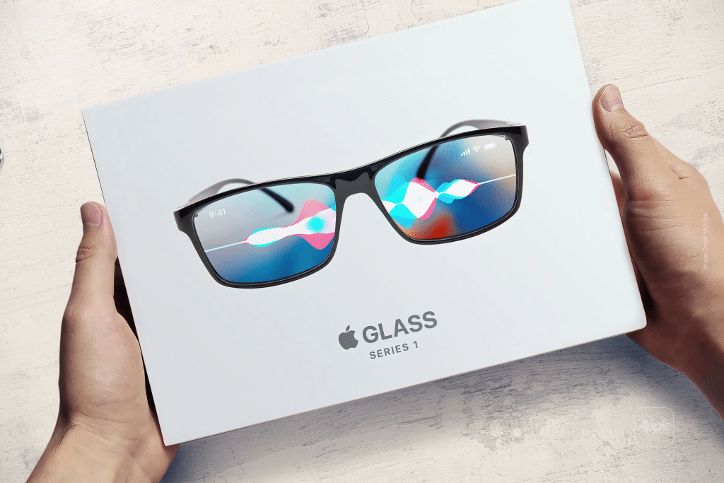 A pair of standalone AR glasses with a digital interface on the lenses, displaying colorful graphics and icons, are placed on top of a white Apple Glass Series 1 box. The box is cradled by two hands on a light wooden surface.