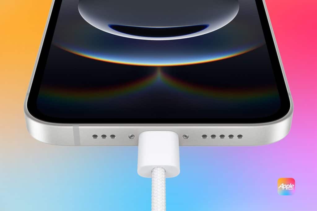 A smartphone with a silver edge is shown from the bottom, with a white charging cable plugged into it. The screen displays a dark circular design. The background is a gradient of orange, pink, and blue. An Apple logo is in the lower right corner.