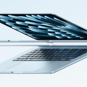 A sleek, silver laptop partially open, showcasing a patterned screen and keyboard, is depicted in a minimalist floating position against a soft, light blue background. The design highlights its thin profile and modern styling, symbolizing a severance from traditional bulky devices.