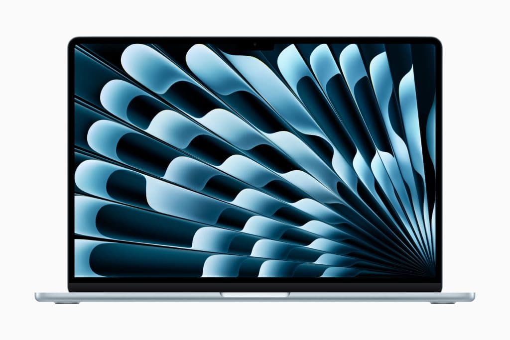 A sleek M4 MacBook Air with a silver body and a black-bordered screen displaying an abstract blue and black spiral pattern. The device is showcased facing forward on a plain white background, highlighting Apple’s embrace of new colors in their design.