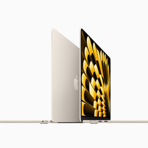 A gold-colored MacBook Air M4 with a sleek design is shown open at a side angle. The screen displays an abstract, geometric pattern in shades of gold and black, perfectly highlighting the latest announcement. The Apple logo stands proud on the back of the screen.