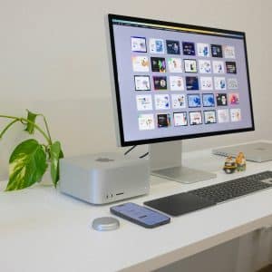 Front view of the new Mac Studio powered by the Apple M3 Ultra chip, showcasing its compact design and high-performance capabilities on a minimalist desk setup.