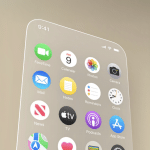 Close-up of a smartphone screen running iOS 19, displaying app icons like FaceTime, Calendar, Photos, Camera, Mail, Notes, Reminders, Clock, News, Apple TV, Podcasts, and App Store. The time shows 9:41.